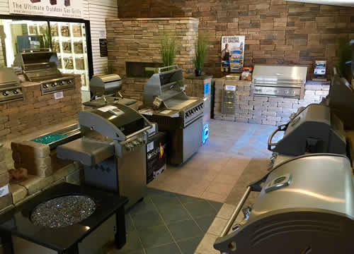 Showroom of several types of outdoor grills and fireplaces.